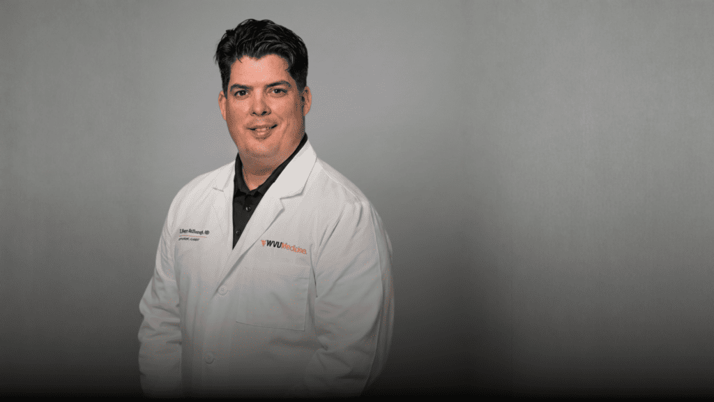 Dental professional in white coat using PrecisionOS virtual reality system.